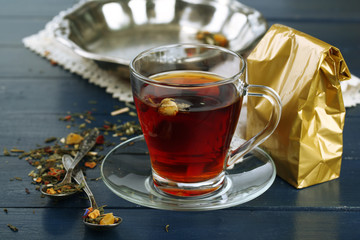 Beautiful vintage composition with herbal tea, on wooden table
