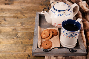Cup of tea with cookies on table close-up