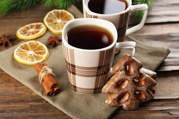 Cups of tea with cookies on table close-up