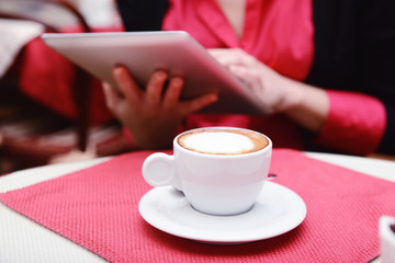 Woman with tablet computer in cafe shop