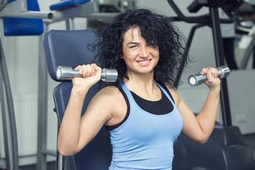 Fototapeta premium young girl goes in for sports in the gym