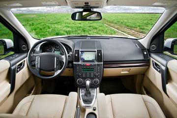 Sand colored SUV car interior in the fields