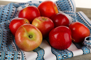 Naklejka na ściany i meble Heap of apples with dishcloth on wooden table background