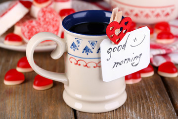 Cup of tea with card that says good morning on table close-up