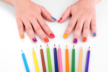 Obraz na płótnie Canvas Multicolor female manicure with colored pencils isolated