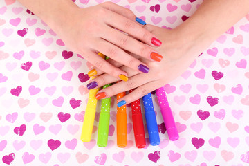 Obraz na płótnie Canvas Multicolor female manicure with markers on bright background
