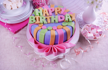 Delicious birthday cake on table close-up