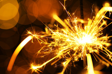 Beautiful sparkler on shiny background, close up