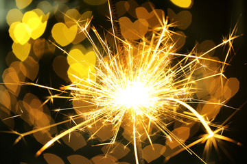 Beautiful sparkler on shiny background, close up