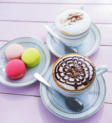 cappuccino coffee in white cup on wooden table
