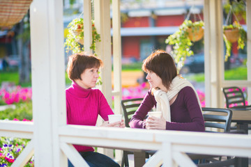 Mother and daughter together in cafe