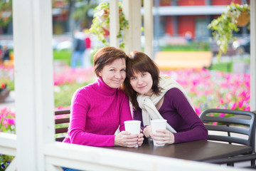 Mother and daughter together in cafe