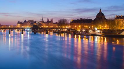 Seine river and Old Town of Paris (France) at night