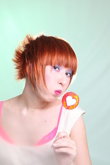 redhead girl with lollipop heart vertically