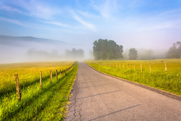 Fototapeta na wymiar Farm fields along a country road on a foggy morning in the Potom