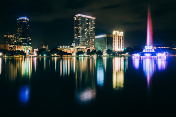 Fountain and the Orlando skyline at night, reflecting in Lake Eo