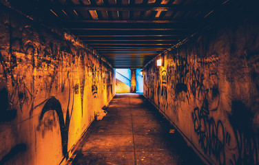 Graffiti in a dark pedestrian tunnel, in Philadelphia, Pennsylva