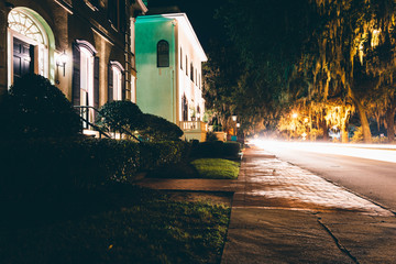 Houses and traffic at night on Drayton Street in Savannah, Georg