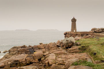 Fototapeta na wymiar Old lighthouse in the cliffs. Atlantic ocean, Brittany, France