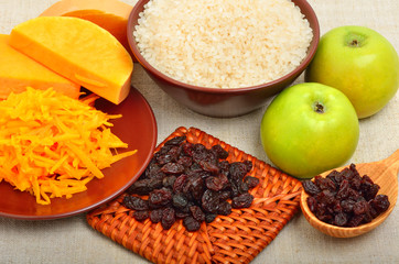 ripe raw pumpkin with grated pumpkin, apples and heap of raisins