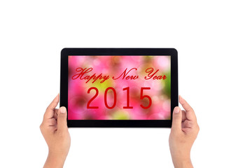 Hand holding tablet with text happy new year 2015