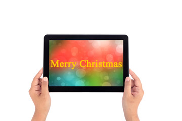 Hand holding tablet with text merry christmas