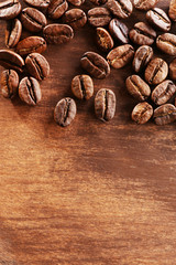 Coffee beans on wooden background, close-up