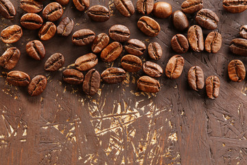 Coffee beans on wooden background, close-up