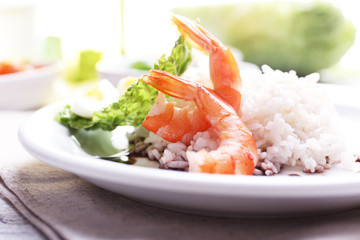 Boiled rice with shrimps served on table, close-up
