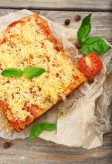 Portion of tasty lasagna on wooden table