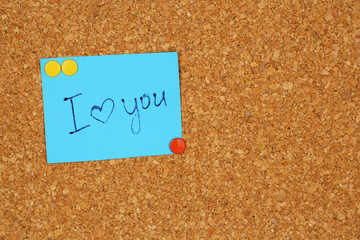 Paper sheet with declaration of love on wooden background