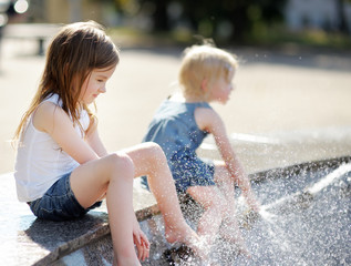 Sisters having fun in a fountain