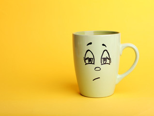 Emotional cup on yellow background