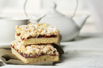 Cup of tea and tasty homemade pie on wooden table