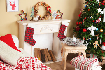 Beautiful Christmas interior with sofa, decorative fireplace