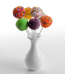 Sweet cake pops in vase isolated on white