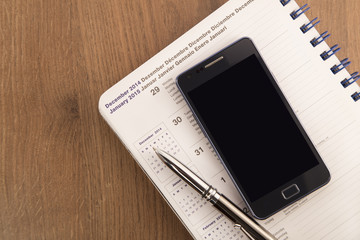 Mobile phone, pen and agenda