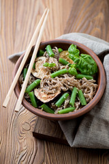 Soba noodles with aubergine slices, beans and sesame seeds