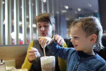 Boy eating foam of milkshake