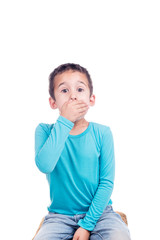 young boy with hand over mouth