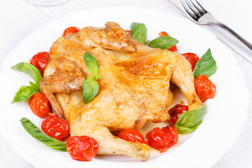 Roast chicken with tomatoes cherry, green basil and garlic