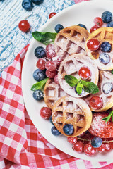 Waffles with fresh berries on the table
