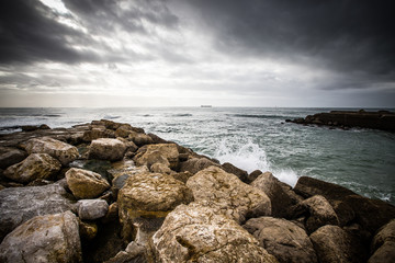 In anticipation of the storm. Dramatic sky on the stone coast of