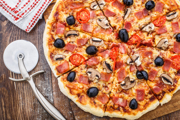 Pizza with ham, mushrooms and olives