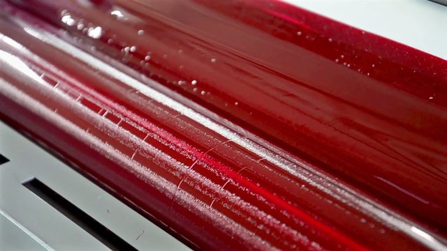Red Paint Running Off a Roller in Offset Printing Press