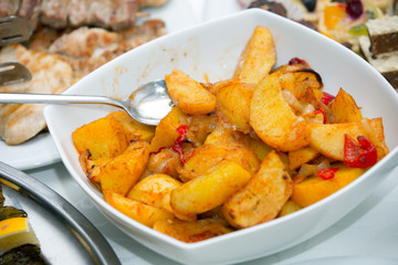 Fried potato wedges on white plate