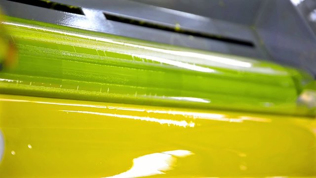Yellow Paint Running Off a Roller in Offset Printing Press