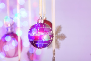 Christmas decorations hanging on festive background
