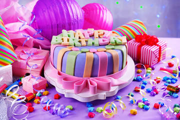 Delicious birthday cake on table close-up