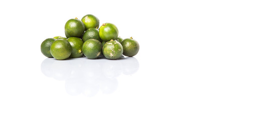 Calamondin or calamansi lime over white background